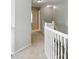 Hallway features neutral walls and carpet, lighting fixtures and a white railing at 13355 Freenza Ct, Carmel, IN 46074