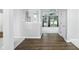 Bright hallway with hardwood floors leads to carpeted rooms with large windows at 13355 Freenza Ct, Carmel, IN 46074