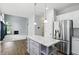 Bright kitchen featuring white cabinets, stainless steel appliances, and granite countertops at 13355 Freenza Ct, Carmel, IN 46074
