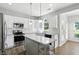Bright kitchen featuring white cabinets, stainless steel appliances, and granite countertops at 13355 Freenza Ct, Carmel, IN 46074