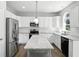 Bright kitchen featuring white cabinets, stainless steel appliances, and granite countertops at 13355 Freenza Ct, Carmel, IN 46074