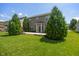 Well-maintained backyard featuring a wooden deck, lush lawn, and mature evergreens at 13992 Wynngate Ln, Fishers, IN 46038