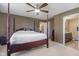 Primary bedroom features neutral carpet with wooden furniture and bathroom access at 13992 Wynngate Ln, Fishers, IN 46038