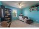 Bright bedroom features a built-in bookshelf and neutral carpeting at 13992 Wynngate Ln, Fishers, IN 46038