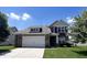 Charming two-story home with a brick and siding exterior, attached two-car garage, and well-manicured lawn at 13992 Wynngate Ln, Fishers, IN 46038