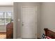 Clean, bright foyer featuring a white door, neutral walls, and a glimpse of hardwood flooring at 13992 Wynngate Ln, Fishers, IN 46038