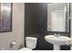 Modern half bathroom with a pedestal sink, toilet, and neutral gray walls at 13992 Wynngate Ln, Fishers, IN 46038