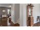 Hallway with hardwood floors and neutral gray walls, showing access to other rooms and the staircase at 13992 Wynngate Ln, Fishers, IN 46038