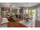 Spacious kitchen with dark cabinetry, stainless steel appliances, and a dining area with backyard views at 13992 Wynngate Ln, Fishers, IN 46038