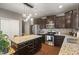 Contemporary kitchen features dark cabinetry, granite countertops, and stainless steel appliances at 13992 Wynngate Ln, Fishers, IN 46038