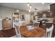 Cozy kitchen and dining area with hardwood floors, vintage furnishings, and modern stainless steel appliances at 13992 Wynngate Ln, Fishers, IN 46038