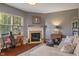 Comfortable living room featuring a fireplace, hardwood floors, and cozy seating area at 13992 Wynngate Ln, Fishers, IN 46038