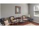 A cozy living room showcases vintage furniture, hardwood flooring, and an elegant mirror at 13992 Wynngate Ln, Fishers, IN 46038
