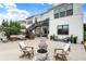 Expansive backyard with a patio, fire pit, seating areas, and stairs to an upper deck at 14682 Braemar E Ave, Noblesville, IN 46062