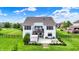 Aerial view of the backyard showcasing the patio, manicured lawn, and serene setting, providing a peaceful escape at 14682 Braemar E Ave, Noblesville, IN 46062