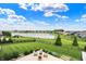 Expansive backyard featuring lush green lawn, mature trees, and a serene lake view in a desirable neighborhood at 14682 Braemar E Ave, Noblesville, IN 46062
