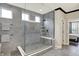 Modern bathroom featuring a glass-enclosed shower with gray tiling, a built-in seat, and sleek fixtures for a spa-like experience at 14682 Braemar E Ave, Noblesville, IN 46062