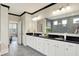 Elegant bathroom with double vanity, sleek countertops, a doorway to the bedroom, and modern fixtures at 14682 Braemar E Ave, Noblesville, IN 46062