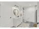 Stylish bathroom features a modern vanity, round mirror, and patterned tile floor at 14682 Braemar E Ave, Noblesville, IN 46062