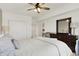 Bright bedroom with white walls, ceiling fan, and closet space, offering a serene retreat at 14682 Braemar E Ave, Noblesville, IN 46062