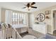 Sunlit bedroom with a crib, dresser, window, and decor, creating a warm and inviting space at 14682 Braemar E Ave, Noblesville, IN 46062