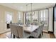 Bright dining room with large windows, modern lighting, and stylish seating for ten at 14682 Braemar E Ave, Noblesville, IN 46062