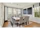 Dining room with large windows and a stylish light fixture with seating for ten at 14682 Braemar E Ave, Noblesville, IN 46062