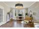 Well-appointed home office featuring hardwood floors, designer lighting, and a comfortable workspace at 14682 Braemar E Ave, Noblesville, IN 46062