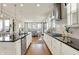 Stylish kitchen with stainless appliances, sleek countertops, and open to dining area with natural light at 14682 Braemar E Ave, Noblesville, IN 46062