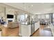Open-concept kitchen with a central island, stainless steel appliances, and a view of the living room and dining area at 14682 Braemar E Ave, Noblesville, IN 46062