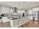 Modern kitchen with a large island, stainless steel appliances, sleek countertops, and ample cabinet space at 14682 Braemar E Ave, Noblesville, IN 46062