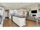 Bright kitchen with stainless steel appliances, a large island, and open access to the living area with a fireplace at 14682 Braemar E Ave, Noblesville, IN 46062