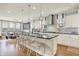 Modern kitchen with a large island, pendant lighting, stainless steel appliances, and open access to the dining area at 14682 Braemar E Ave, Noblesville, IN 46062