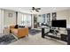 Inviting living room with leather couch, plush rugs, work space and natural light streaming through large window at 14682 Braemar E Ave, Noblesville, IN 46062