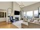 Bright and airy living room with a fireplace, hardwood floors, and plenty of natural light; perfect for entertaining at 14682 Braemar E Ave, Noblesville, IN 46062