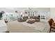 Expansive living room with a comfortable sofa, large windows, and an adjacent dining area at 14682 Braemar E Ave, Noblesville, IN 46062