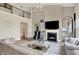 Spacious living room with a cozy fireplace, elegant decor, hardwood floors, and an open layout at 14682 Braemar E Ave, Noblesville, IN 46062