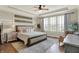 Relaxing main bedroom featuring tray ceilings, a ceiling fan, and large windows that offer natural light and views at 14682 Braemar E Ave, Noblesville, IN 46062