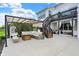 Large patio featuring a covered pergola, comfortable seating, and stairs to an upper level at 14682 Braemar E Ave, Noblesville, IN 46062