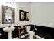 Stylish powder room featuring a unique mirror, elegant fixtures, and a sophisticated design at 14682 Braemar E Ave, Noblesville, IN 46062