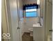 Well-lit bathroom with a toilet, sink, and storage at , Lebanon, IN 46052