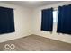 Carpeted bedroom featuring neutral walls, dark curtains and a window at , Lebanon, IN 46052