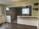 View of living room with fan and view of exterior. Includes bar seating and hardwood floors at , Lebanon, IN 46052