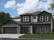 New two-story home boasts a brick facade, attached two-car garage, and modern architectural details at 171 Ames Dr, Whiteland, IN 46184