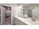 Bright bathroom featuring double vanity, white countertops, sliding door to the shower room, and neutral color scheme at 17303 Lillian St, Westfield, IN 46074