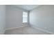 This simple and clean bedroom offers cozy carpet, and natural light through a window, creating a peaceful retreat at 17303 Lillian St, Westfield, IN 46074