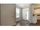 Welcoming foyer with light gray walls, wood-look floors, a white door, and a window with white blinds at 17303 Lillian St, Westfield, IN 46074