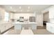 Bright, white kitchen featuring an island with a sink, stainless steel appliances, and ample storage space at 17303 Lillian St, Westfield, IN 46074