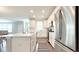 Modern kitchen features white cabinets, stainless steel appliances, island with sink, and an adjacent dining area at 17303 Lillian St, Westfield, IN 46074