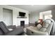 Comfortable living room featuring a fireplace, hardwood floors, modern lighting, and neutral decor at 17303 Lillian St, Westfield, IN 46074